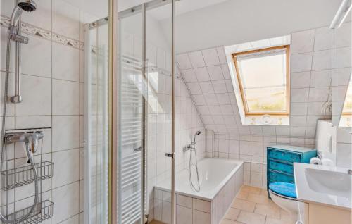 a bathroom with a shower and a tub and a sink at Stunning Apartment In Wendisch Evern With Wifi in Wendisch Evern