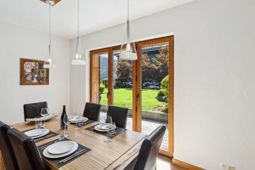 a dining room with a wooden table and chairs at The Lodge by Mrs Miggins in Champéry