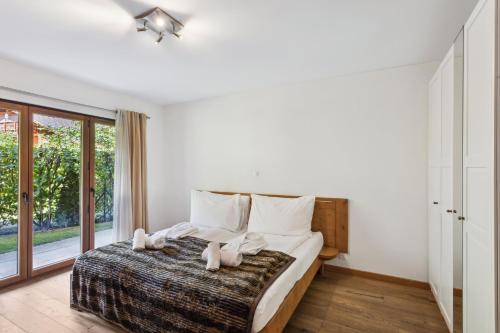 a bedroom with a large bed with white pillows at The Lodge by Mrs Miggins in Champéry