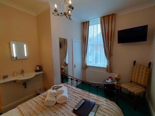 a hotel room with a bed and a sink at Arden House in Harrogate