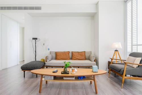 a living room with a couch and a coffee table at Lidcombe 2Br Apt Near Olympic Park Train Shopping Center in Sydney