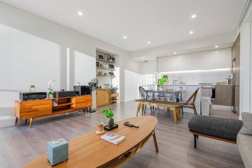 a living room with a couch and a table at Lidcombe 2Br Apt Near Olympic Park Train Shopping Center in Sydney