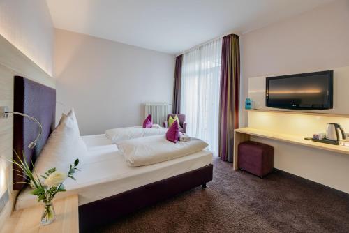 En eller flere senge i et værelse på Concorde Hotel am Leineschloss