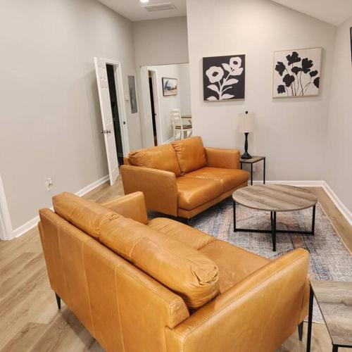 a living room with a couch and a table at Stylish Cottage Near Airport in Atlanta