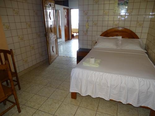 Un dormitorio con una cama con una vela. en HOSTAL RESIDENCIAL UCAYALI en Tingo María