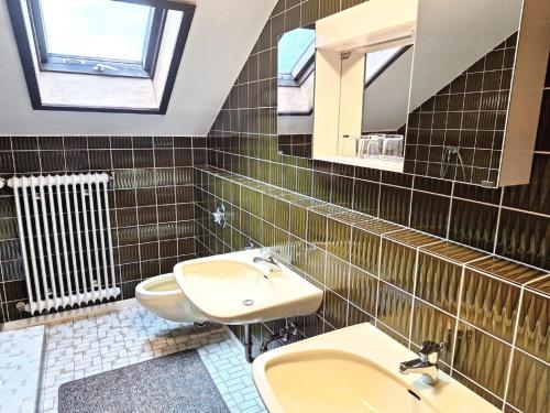 a bathroom with a sink and a toilet and a mirror at Pension Schneider in Frauenau