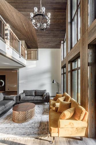 a living room with a couch and a table at Ranča in Molėtai