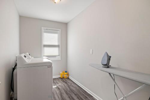 a laundry room with a washing machine and a window at The Sanctuary - Work Friendly & Near Downtown in Indianapolis