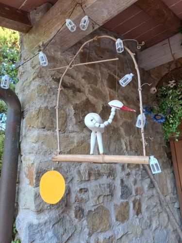 a person hanging on a stone wall with lights at B&B La Dimora di Alida in Fiesole