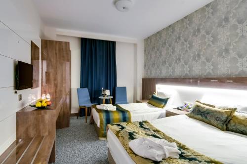Ένα ή περισσότερα κρεβάτια σε δωμάτιο στο PARK YALÇIN HOTEL