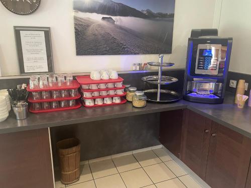 a counter in a coffee shop with food and drinks at Fasthotel Annecy in Annecy