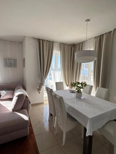 a dining room with a white table and chairs at Villa Iva in Dubrovnik