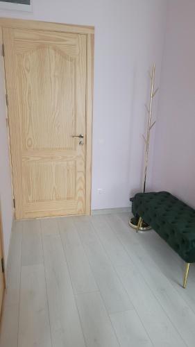 a room with a door and a bench in front of it at Dzintara apartamenti in Kuldīga