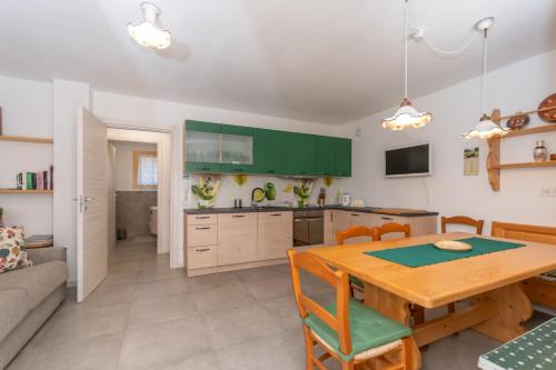 a kitchen and dining room with a wooden table at Casa Carducci in Alleghe