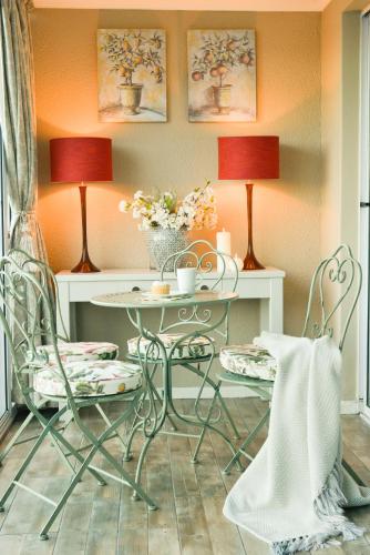 a room with two chairs and a table with two lamps at dk villas 1 Harbour View Hout Bay in Hout Bay