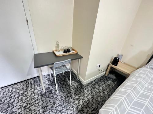 a small table in a room with a bed at IBROX GuestHouse in Glasgow