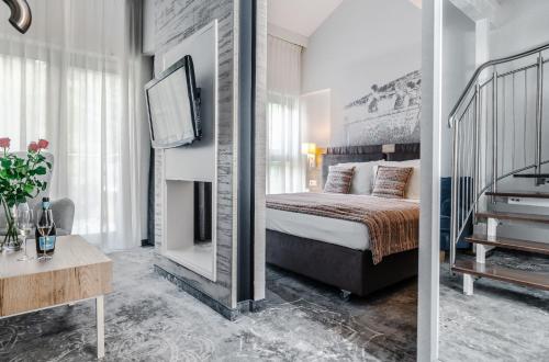 a bedroom with a bed and a tv in a room at Hotel Aquarion Family & Friends - Destigo Hotels in Zakopane