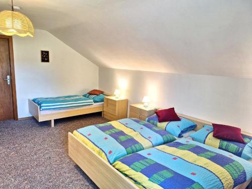 two beds in a room with two beds sidx sidx sidx sidx at Pension Schneider in Frauenau