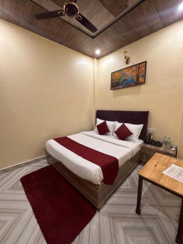 a bedroom with a large bed and a table at The Peninsulla in Rishīkesh