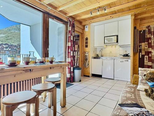 une cuisine avec un comptoir et des tabourets dans une pièce dans l'établissement Appartement pour 4 avec balcon à Tignes-Le Lavachet - FR-1-411-746, à Tignes