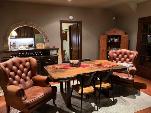 a dining room with a table and two chairs at Villa Sol Luxury Costa Brava Golf in Peralada