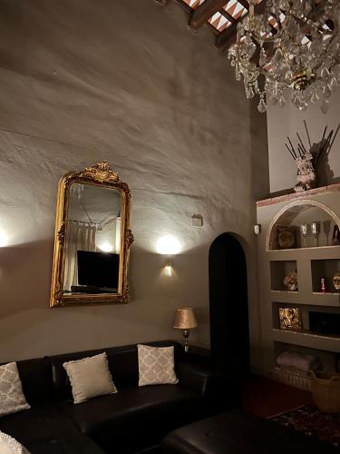 a living room with a black couch and a mirror at Villa Sol Luxury Costa Brava Golf in Peralada