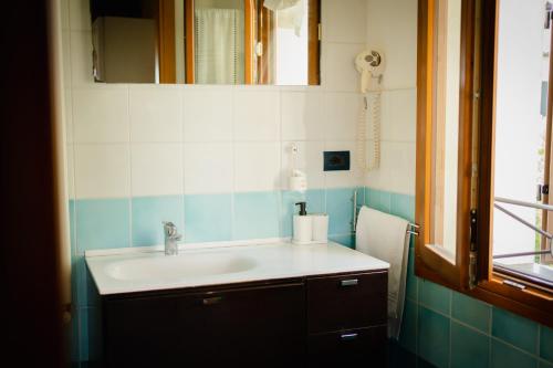 a bathroom with a sink and a mirror at SPIEDO IMPERIALE - Locanda e Ristorante in Cotignola