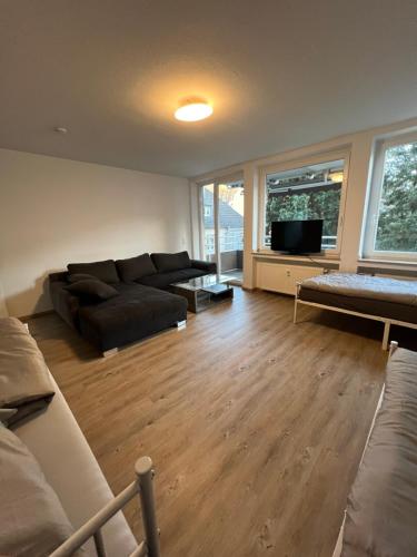 a living room with a couch and a tv at Unterkunft NRW ID1 in Leverkusen