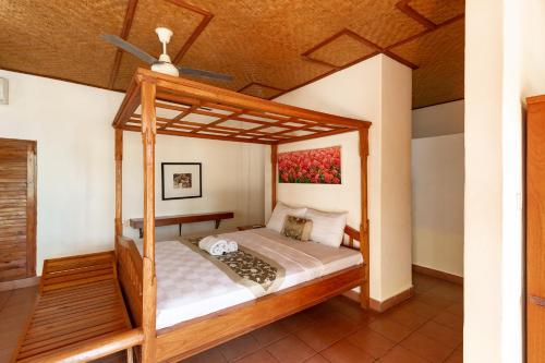 a bedroom with a canopy bed in a house at Vedanta Villa in Lovina
