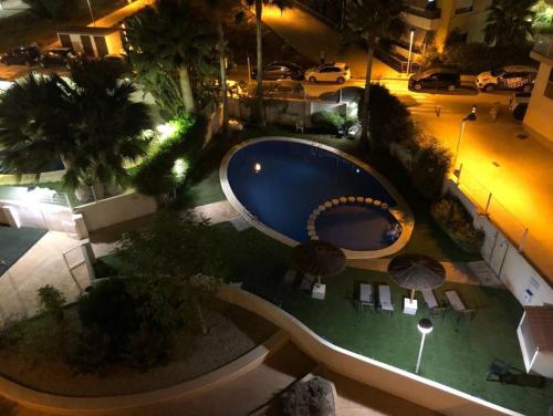 Una vista aérea de una piscina por la noche. en ATICO MORAIRA, en Moraira