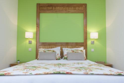 a bedroom with a large bed with two pillows at Agro-Turismo do ROXO in Santa Vitória
