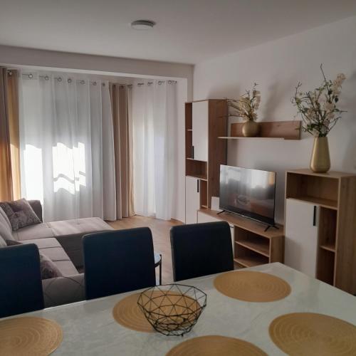 a living room with a couch and a table at Spa Koncept-Apartmani in Veliko Gradište