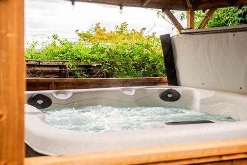 a bath tub with water in it on a patio at Stag Manor Hot Tub Retreat near Peak District in Crich