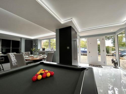 a pool table with balls on top of it in a living room at Moonsticks in Norwich