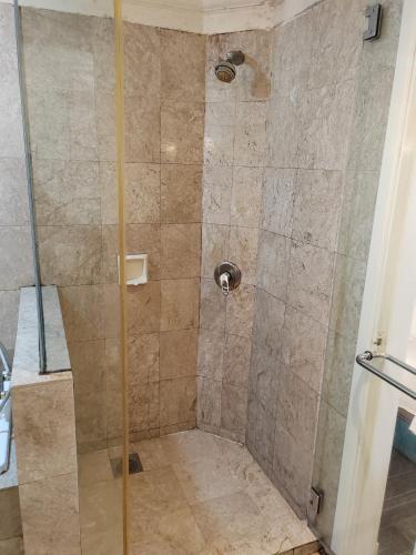 a shower with a glass door in a bathroom at Kl Continew Suite At Times Square in Kuala Lumpur
