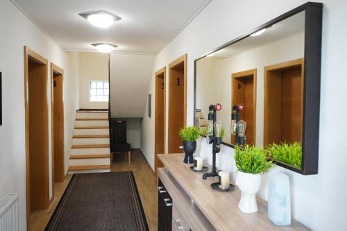 a bathroom with a large mirror on the wall at Apartman - Sobe Tiha Luka, Bjelašnica in Bjelašnica