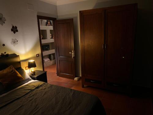 a bedroom with a bed and a wooden closet at Villa Sol Luxury Costa Brava Golf in Peralada