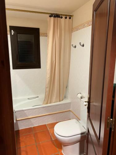 a bathroom with a toilet and a bath tub at Villa Sol Luxury Costa Brava Golf in Peralada