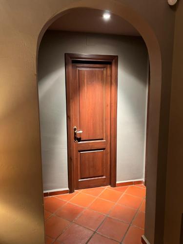 a hallway with a wooden door in a room at Villa Sol Luxury Costa Brava Golf in Peralada