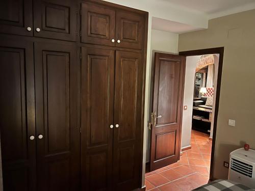 a hallway with wooden cabinets and a door to a room at Villa Sol Luxury Costa Brava Golf in Peralada