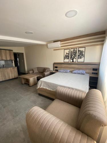 a large bedroom with a bed and a couch at The Blue House in Burgaz