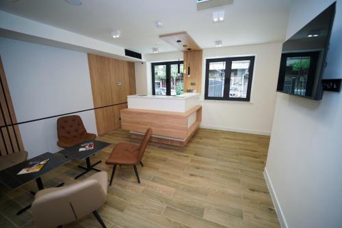 a lobby with a waiting area with chairs and a table at B&M Hotel in Yerevan