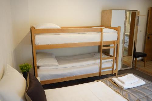 a room with two bunk beds with a mirror at Apartman - Sobe Tiha Luka, Bjelašnica in Bjelašnica