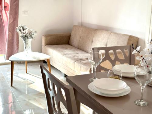 a living room with a table and a couch at Shell Home golem 1 in Golem