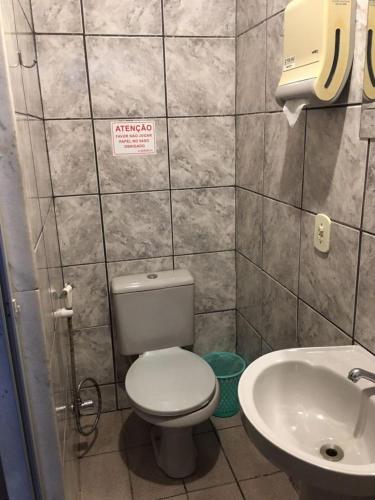 a small bathroom with a toilet and a sink at New York in Juiz de Fora