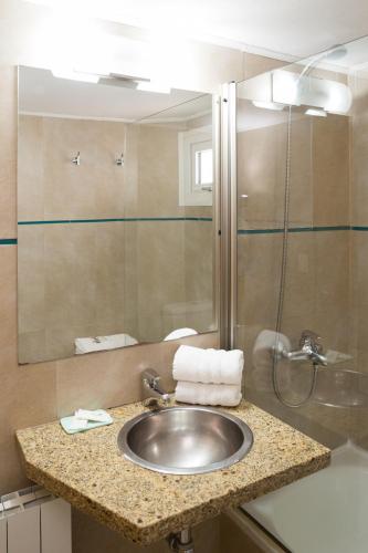 a bathroom with a sink and a shower at NBH Premier Hotel in San Carlos de Bariloche