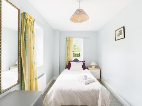 a bedroom with a bed and a large mirror at Pass the Keys Conventional and Homely 3Bed in Alderminster in Stratford-upon-Avon