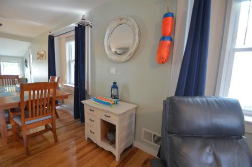 a living room with a chair and a table and a mirror at Riverfront Retreat! Water front and dog friendly! in Two Rivers