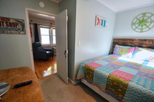 a bedroom with a bed with a quilt on it at Riverfront Retreat! Water front and dog friendly! in Two Rivers