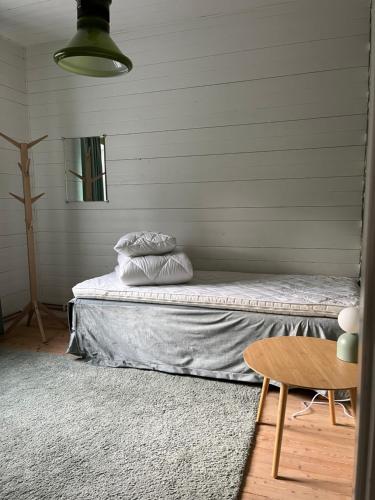 a bed with two pillows on it in a room at Vintergatans Rum in Insjön